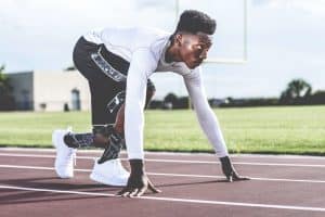 Athletes Using CBD: An Athlete on a Track Getting Ready to Run